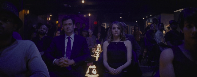 Wide shot frame from La La Land — sitting, standing, room