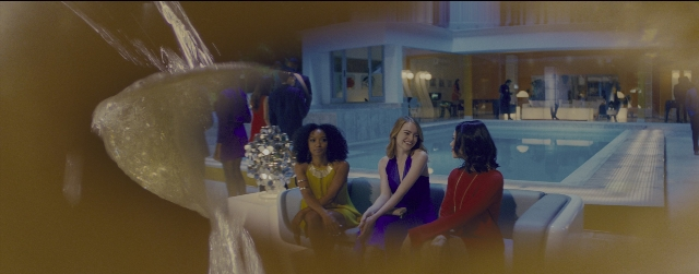 Wide shot frame from La La Land — sitting, dialogue, couch