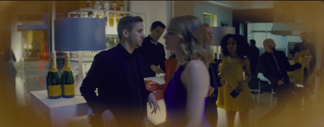 Wide shot frame from La La Land — standing, room, table