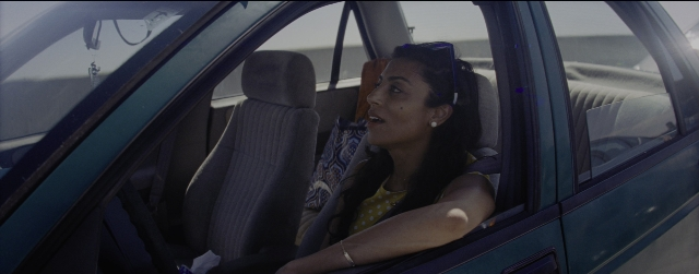 Wide shot frame from La La Land — sitting, street, car