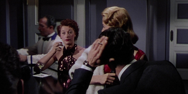 Wide shot frame from Magnificent Obsession — standing, room, table