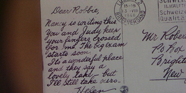 Wide shot frame from Magnificent Obsession — envelope, person