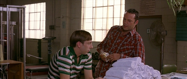 Wide shot frame from Dodgeball: A True Underdog Story — sitting, standing, room
