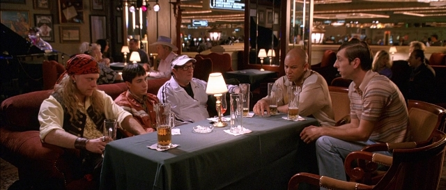 Wide shot frame from Dodgeball: A True Underdog Story — sitting, table, dialogue