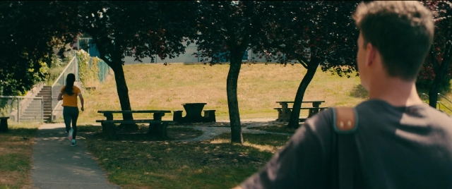 Wide shot frame from To All the Boys I've Loved Before — walking, bench, person