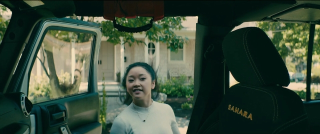 Wide shot frame from To All the Boys I've Loved Before — sitting, car, shirt
