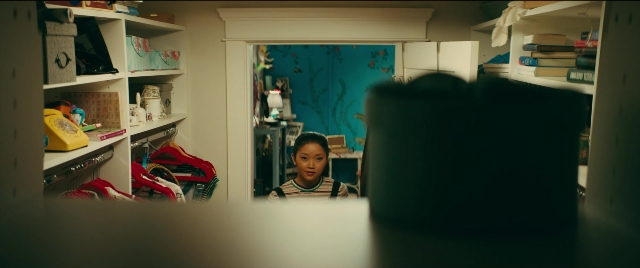 Wide shot frame from To All the Boys I've Loved Before — book, standing, room
