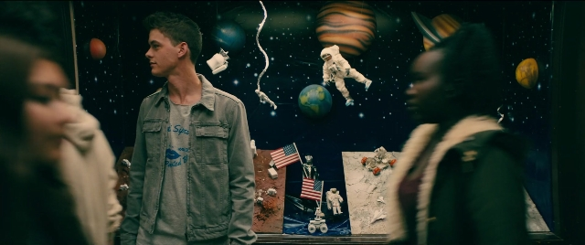 Wide shot frame from To All the Boys I've Loved Before — standing, suit, face