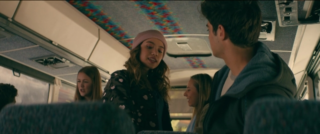 Wide shot frame from To All the Boys I've Loved Before — sitting, standing, bus
