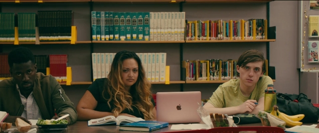 Wide shot frame from To All the Boys I've Loved Before — sitting, book, plate