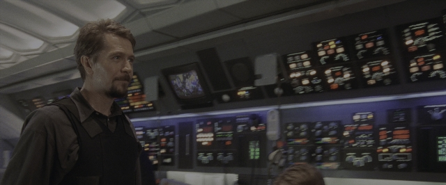 Wide shot frame from Air Force One — standing, room, shirt