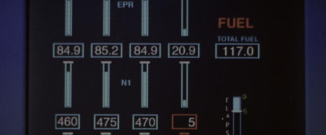 Wide shot frame from Air Force One — car, digital clock