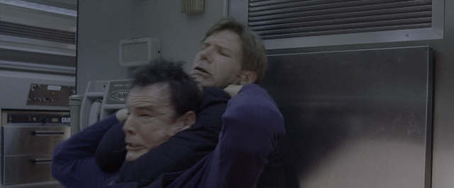 Wide shot frame from Air Force One — room, face, hair