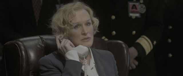 Medium shot frame from Air Force One — sitting, dialogue, phone