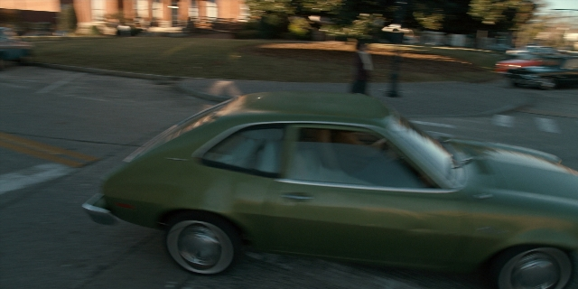 Frame from Stranger Things — walking, door, street