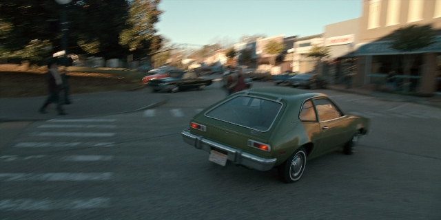 Frame from Stranger Things — walking, street, car