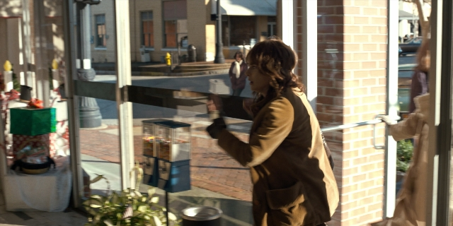Wide shot frame from Stranger Things — standing, walking, door