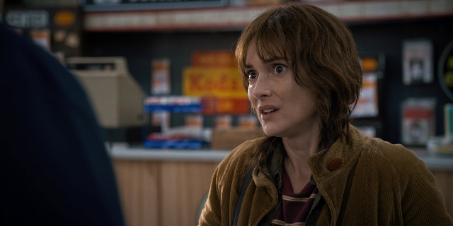 Wide shot frame from Stranger Things — standing, room, hand