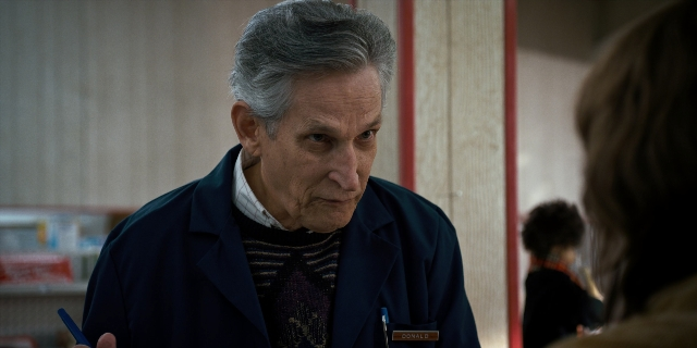 Wide shot frame from Stranger Things — room, hand, shirt