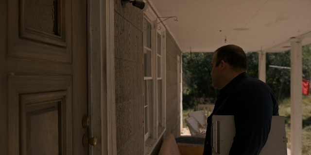 Wide shot frame from Stranger Things — standing, door, hand