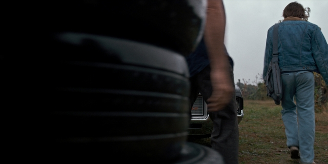 Medium shot frame from Stranger Things — walking, car, jacket