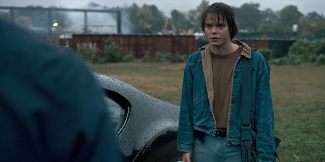 Wide shot frame from Stranger Things — standing, car, shirt