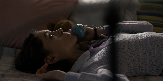 Wide shot frame from Stranger Things — bed, bedroom, face
