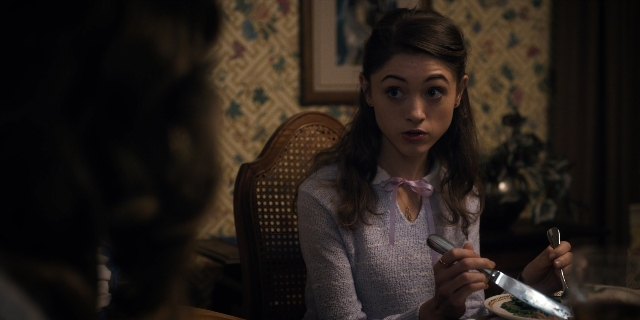 Wide shot frame from Stranger Things — sitting, plate, room