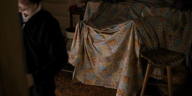 Wide shot frame from Stranger Things — standing, room, table