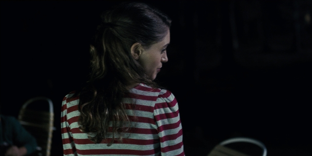 Wide shot frame from Stranger Things — sitting, standing, room