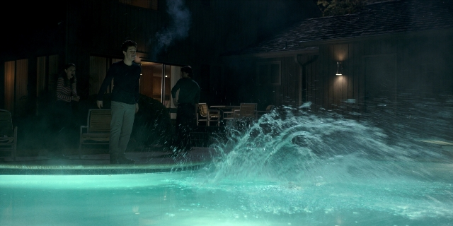 Wide shot frame from Stranger Things — standing, night, water