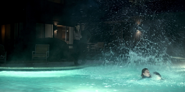 Wide shot frame from Stranger Things — standing, night, water
