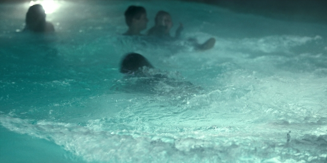 Wide shot frame from Stranger Things — room, water, person