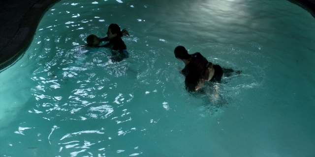 Wide shot frame from Stranger Things — standing, water, person