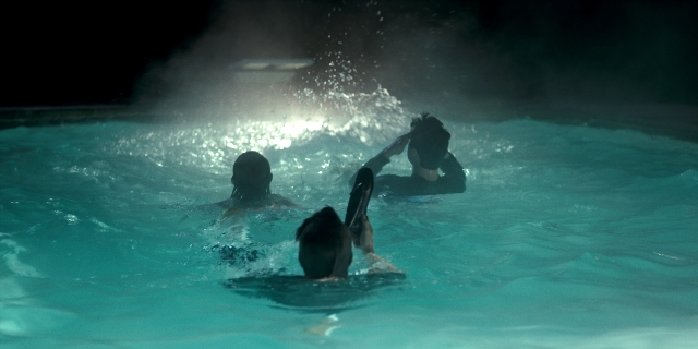 Wide shot frame from Stranger Things — night, water, person