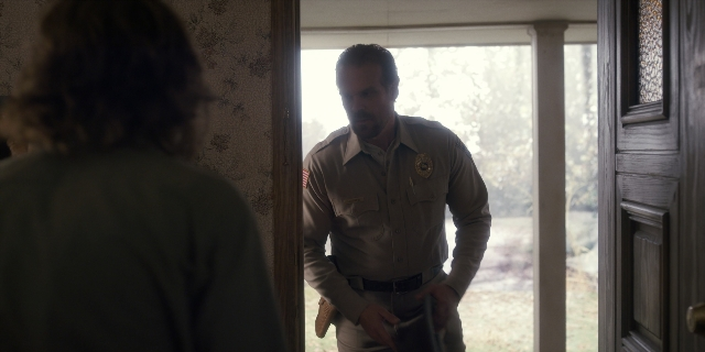 Wide shot frame from Stranger Things — standing, door, uniform