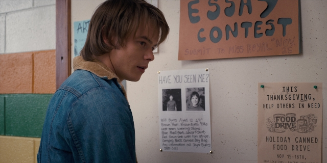 Wide shot frame from Stranger Things — standing, food, face