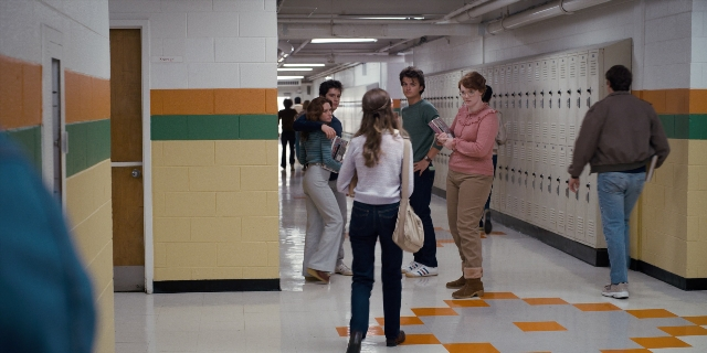 Wide shot frame from Stranger Things — book, walking, shirt