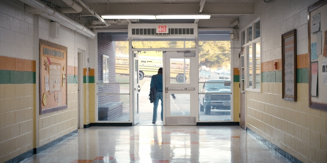 Wide shot frame from Stranger Things — walking, door, car