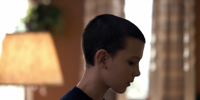 Frame from Stranger Things — standing, room, shirt
