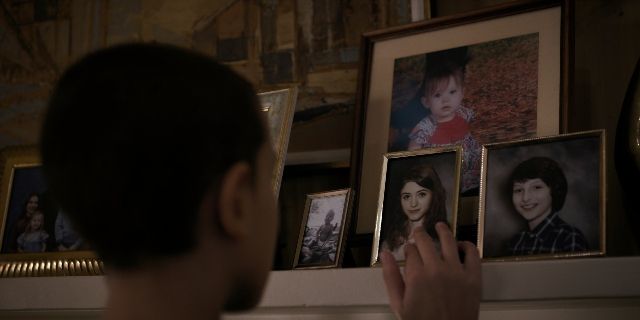 Wide shot frame from Stranger Things — standing, hand, clock