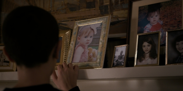 Wide shot frame from Stranger Things — standing, room, shirt
