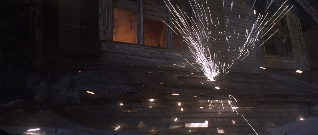 Wide shot frame from Tank Girl — house, snow, window