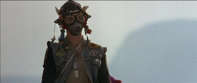 Frame from Tank Girl — hat, jacket, face