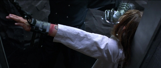 Frame from Tank Girl — coat, hand, hair