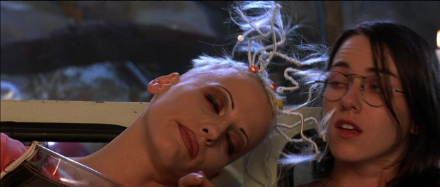 Wide shot frame from Tank Girl — standing, room, hair