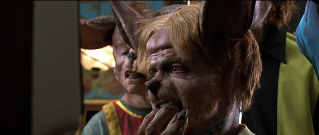 Wide shot frame from Tank Girl — dog, face, person