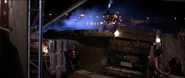 Wide shot frame from Tank Girl — standing, night, smoke