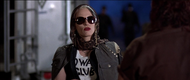 Medium shot frame from Tank Girl — dialogue, jacket, face