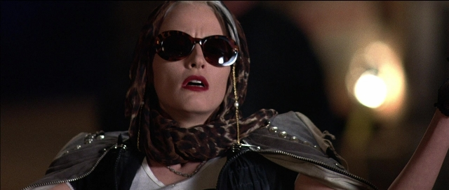 Medium shot frame from Tank Girl — room, face, hair